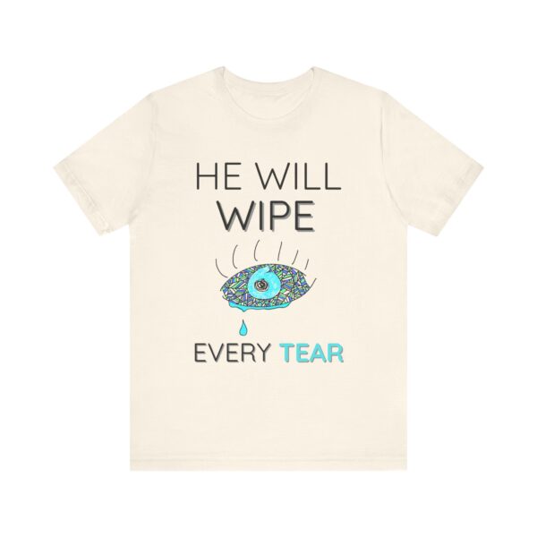the front of a beige t-shirt with a big eye with a tear and text