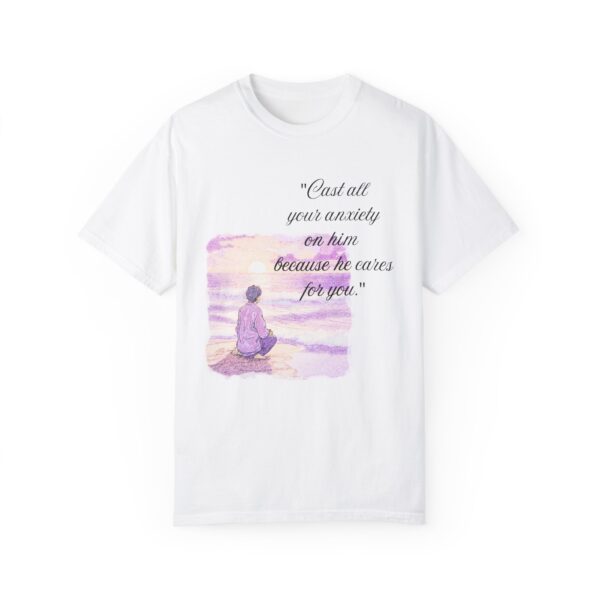 the front of a white t-shirt with text on it and a calm guy sitting at a beach