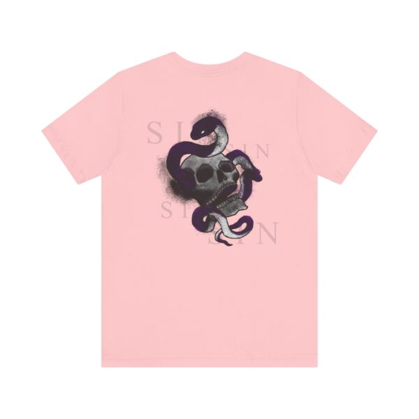 the back of a pink t-shirt with a snake inside a skull and text around it